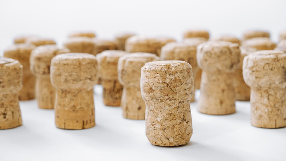 Used Corks Plugs From Different Champagne Producing on White Background